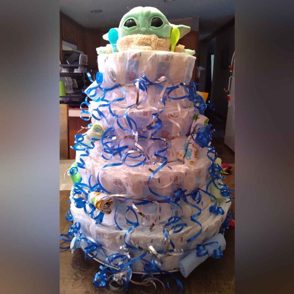 Hand made diaper cake with accessories attached